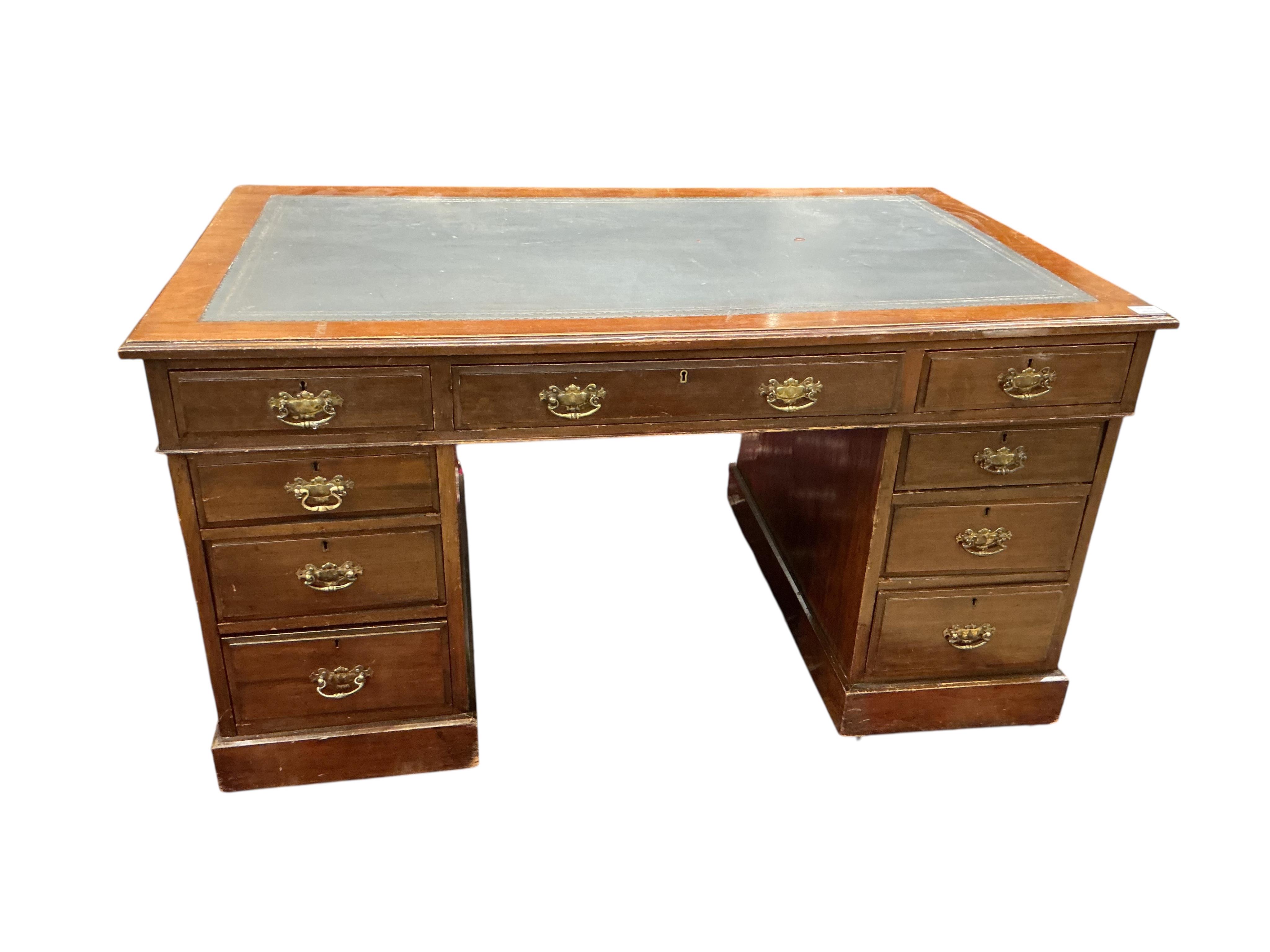 A late Victorian mahogany pedestal desk, fitted nine small drawers, width 138cm, depth 82cm, height 74cm